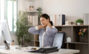 Women having a neck pain while working