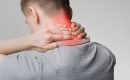 Man holding neck in pain with red area showing inflammation or cervical discomfort