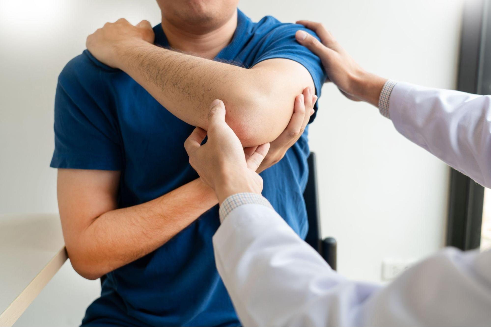 A physiotherapist evaluating a patient's hand during a treatment session